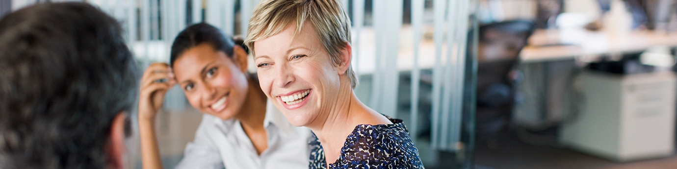 Women smiling in business meeting