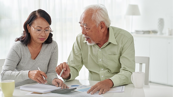 A woman helping her father with finances.