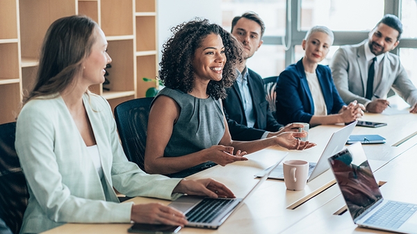 Team of businesspeople sitting together at a meeting in the office