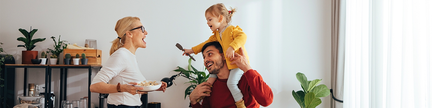 Family playing while cooking in the kitchen