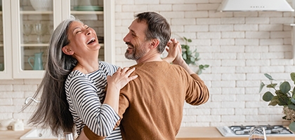 Happy couple dancing together in the kitchen