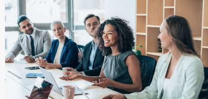 Team of businesspeople sitting together at a meeting in the office.