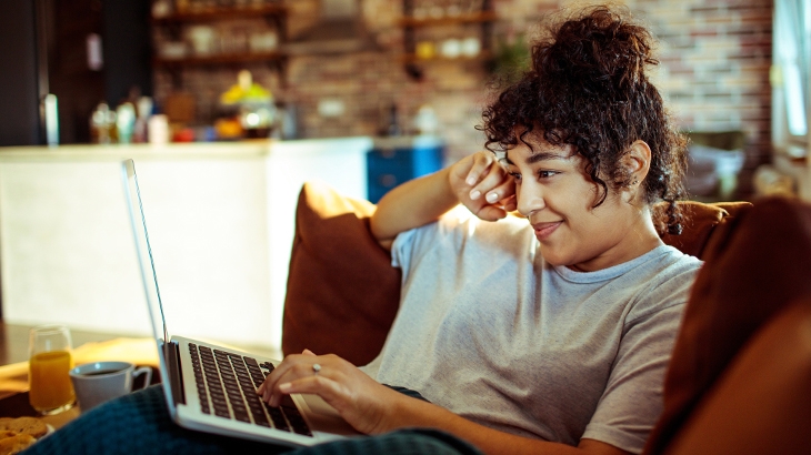 Woman using a laptop at home.