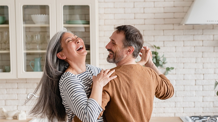 Happy couple dancing together in the kitchen