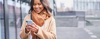 Woman walking outside while on a mobile phone.