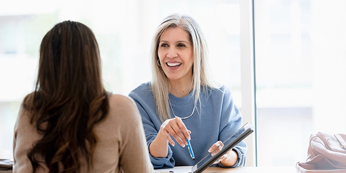 Businesswoman talking with client in office.