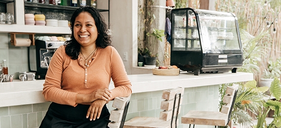 Business owner sitting at cafe bar stool