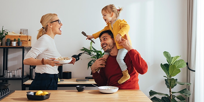 Family playing while cooking in the kitchen