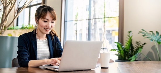 Businesswoman working on laptop at office desk