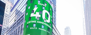 WaFd employees in Times Square NYC with WaFd Nasdaq sign