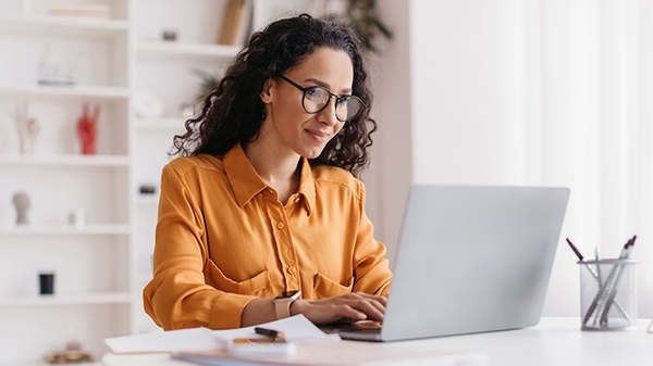 Businesswoman sitting in an office with a laptop