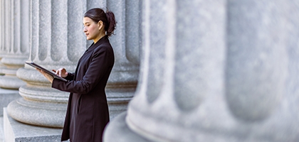 Female lawyer in front of the courthouse.